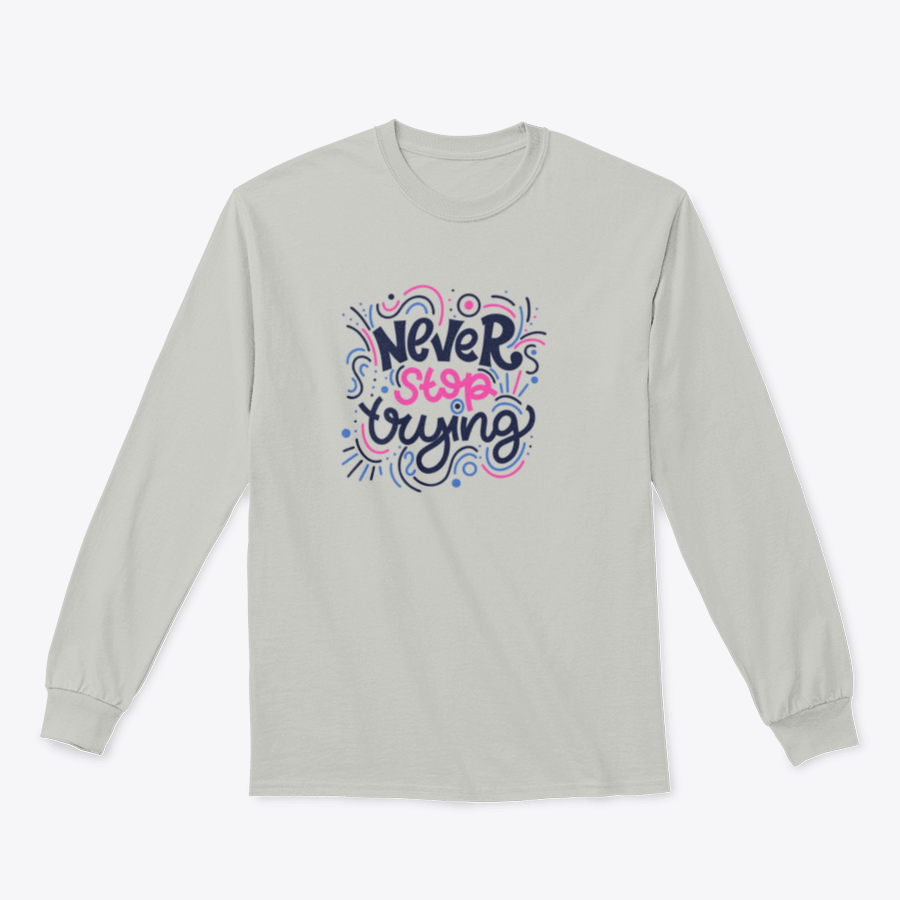 A vibrant t-shirt featuring the motivational phrase 'Never Stop Trying' in bright colored letters, showcasing a modern hand-drawn design.