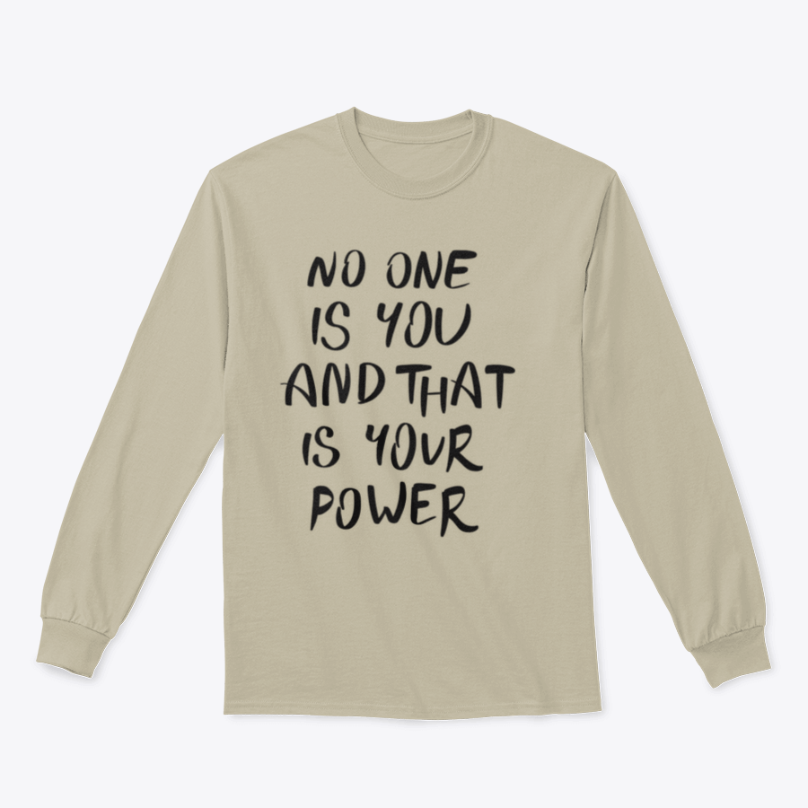 A stylish t-shirt featuring the hand-written calligraphy quote 'No One Is You And That Is Your Power' on a soft cotton fabric.