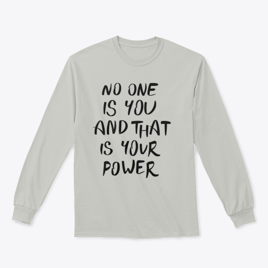 A stylish t-shirt featuring the hand-written calligraphy quote 'No One Is You And That Is Your Power' on a soft cotton fabric.