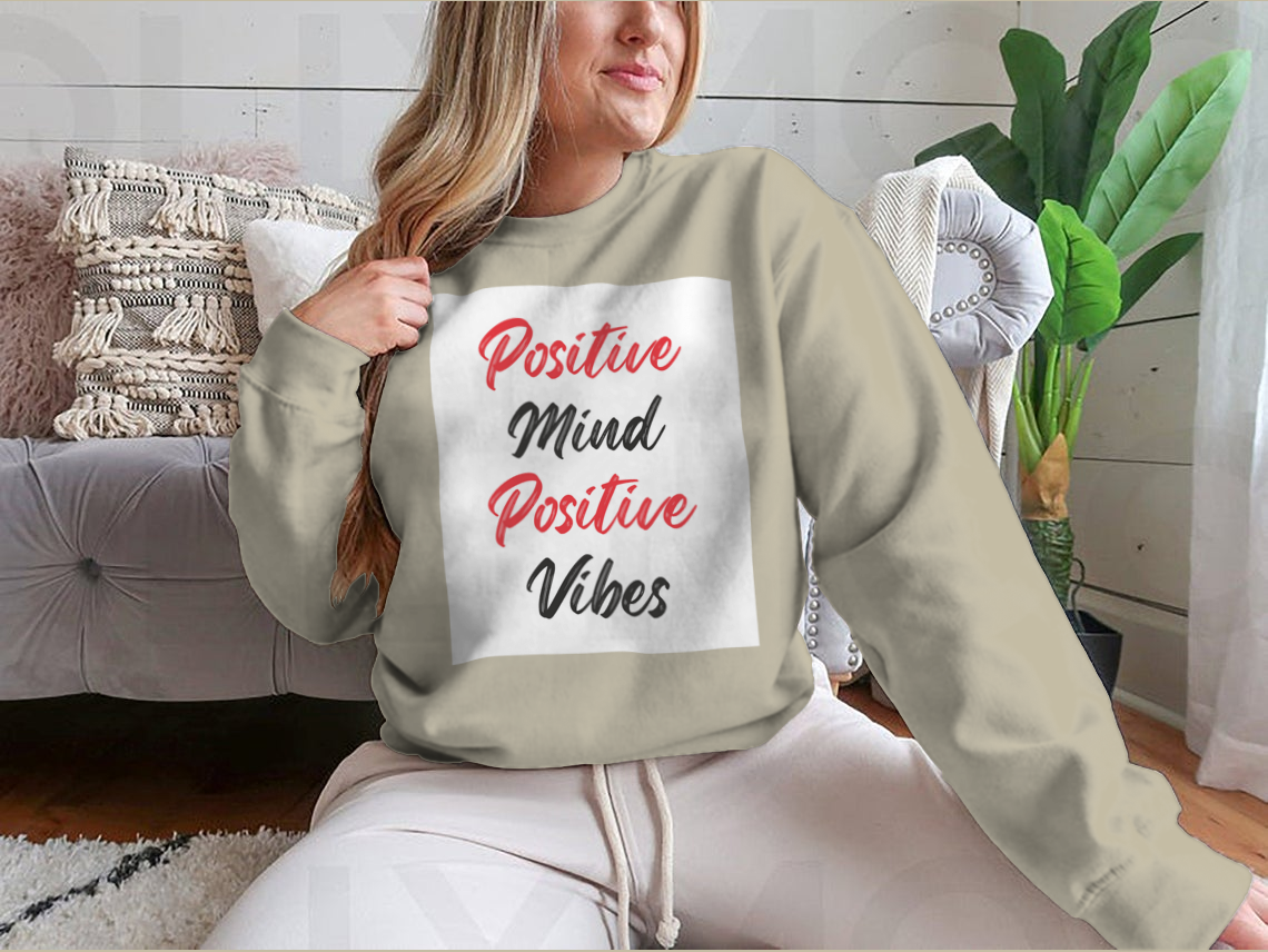 A cozy sweatshirt featuring a stylish calligraphy design that reads 'Positive Mind Positive Vibes', perfect for casual wear.