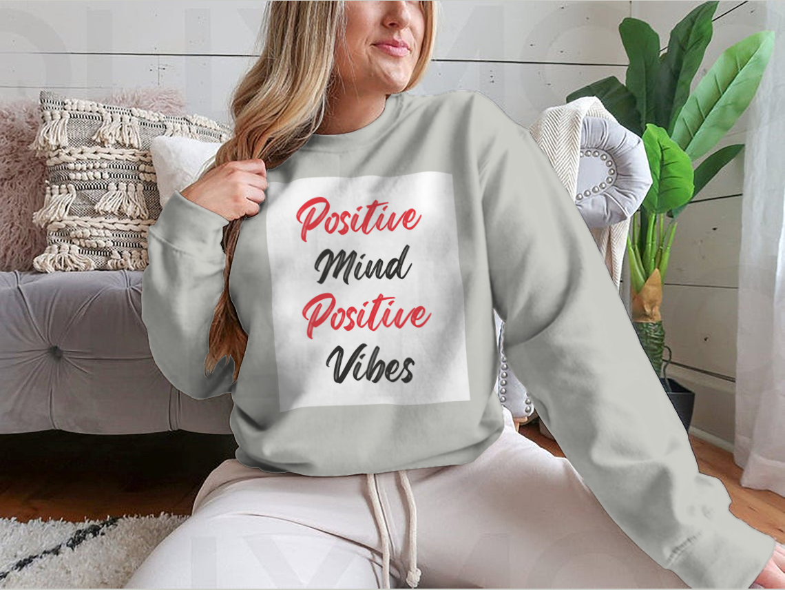 A cozy sweatshirt featuring a stylish calligraphy design that reads 'Positive Mind Positive Vibes', perfect for casual wear.