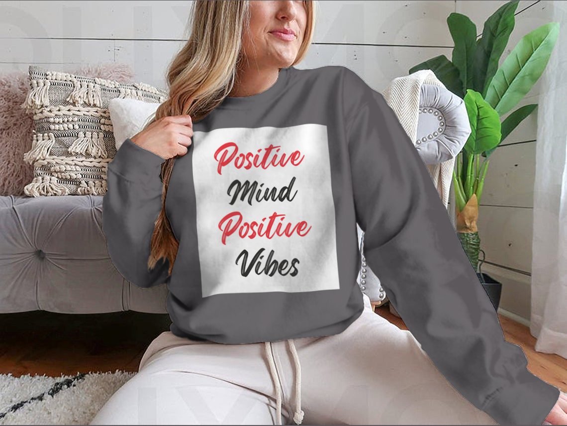 A cozy sweatshirt featuring a stylish calligraphy design that reads 'Positive Mind Positive Vibes', perfect for casual wear.