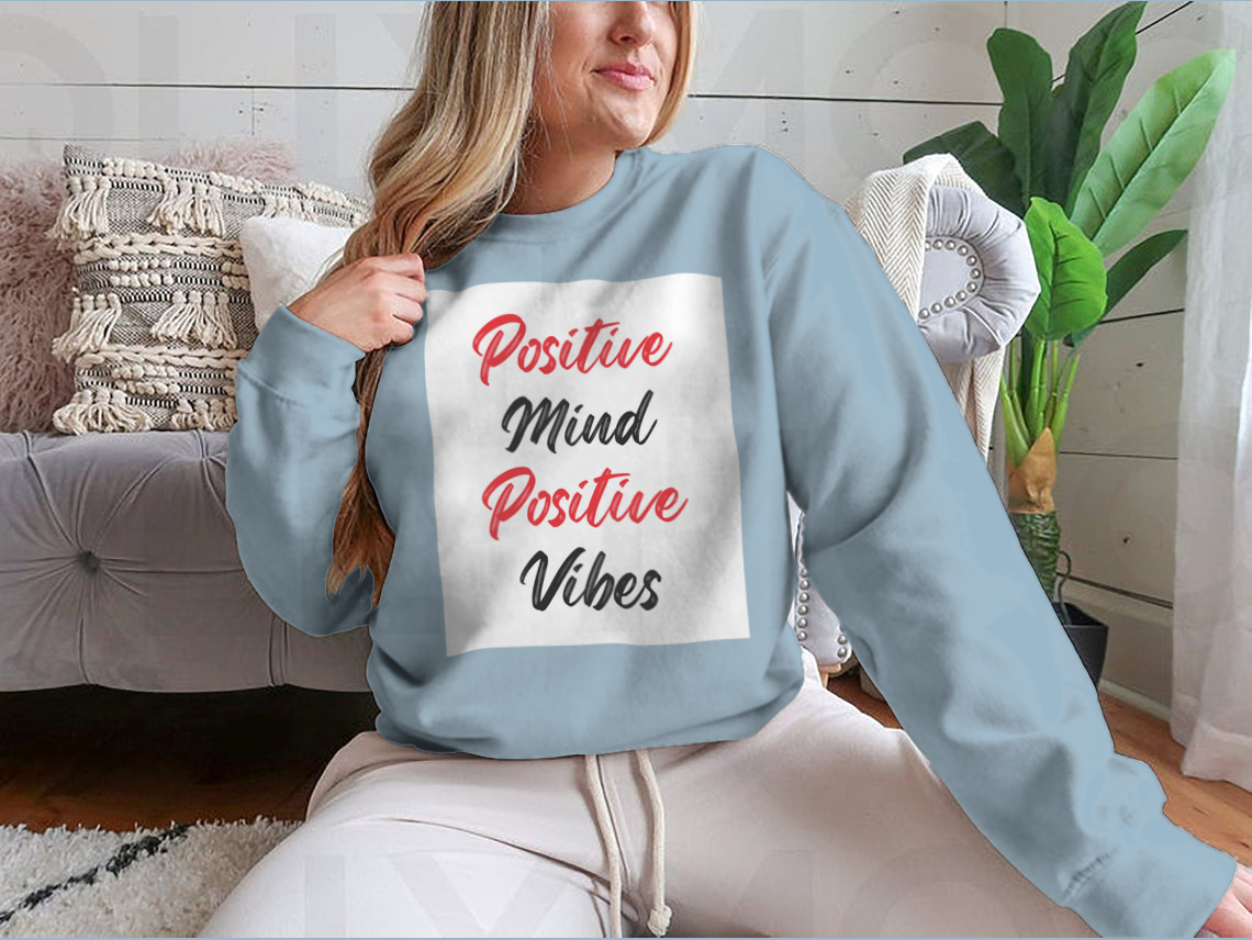 A cozy sweatshirt featuring a stylish calligraphy design that reads 'Positive Mind Positive Vibes', perfect for casual wear.