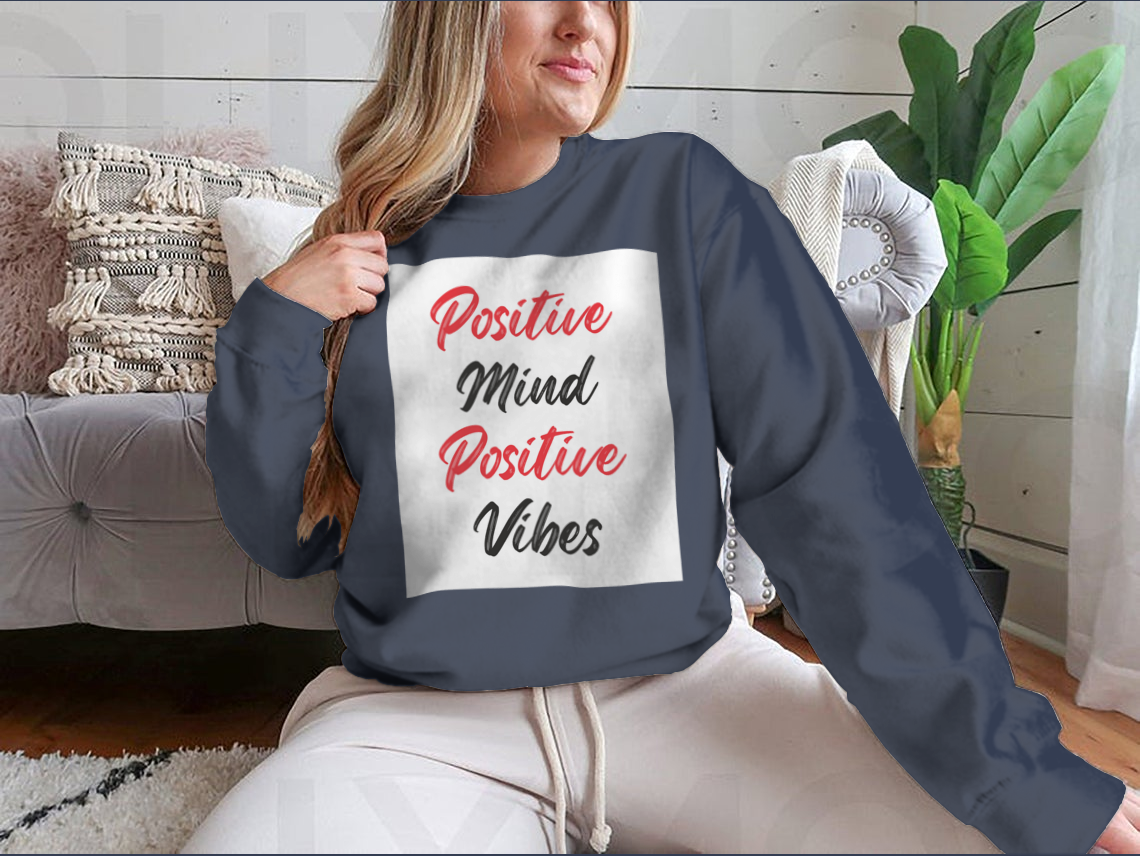 A cozy sweatshirt featuring a stylish calligraphy design that reads 'Positive Mind Positive Vibes', perfect for casual wear.