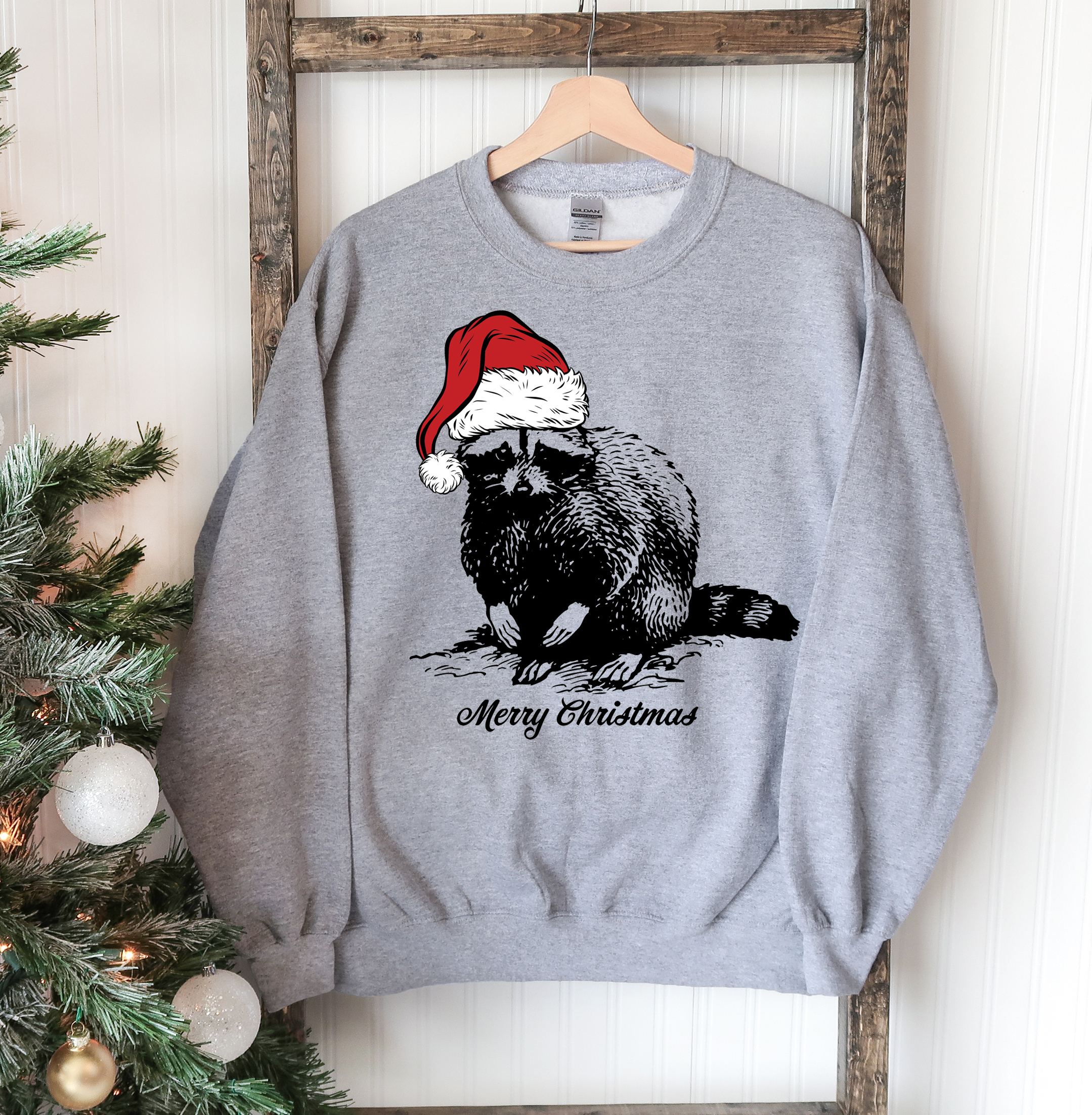 A cozy Racoon Christmas Sweatshirt featuring a festive racoon design, perfect for holiday celebrations and casual wear.