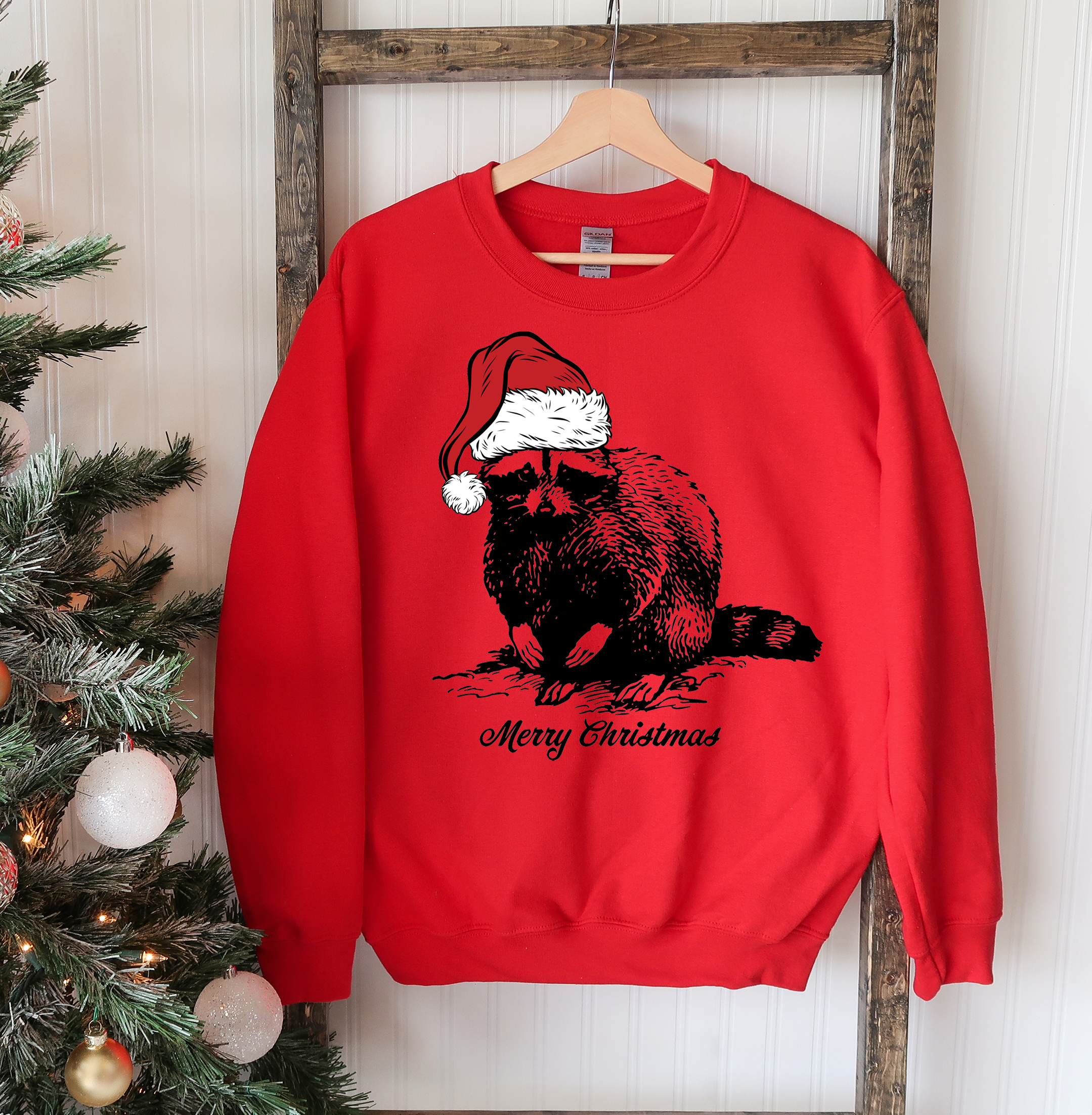 A cozy Racoon Christmas Sweatshirt featuring a festive racoon design, perfect for holiday celebrations and casual wear.