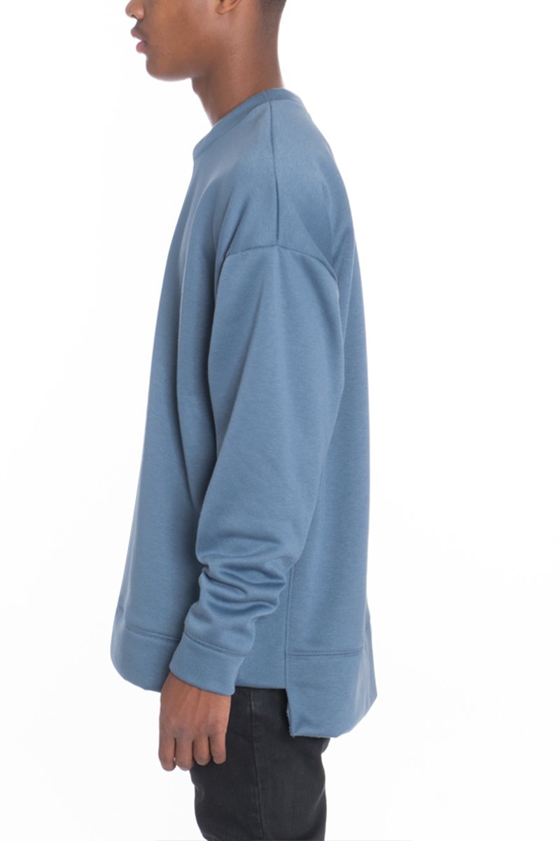 SIDEPANEL PULLOVER featuring a round neck, high-low design, and slit hem, made from a soft cotton-polyester blend.