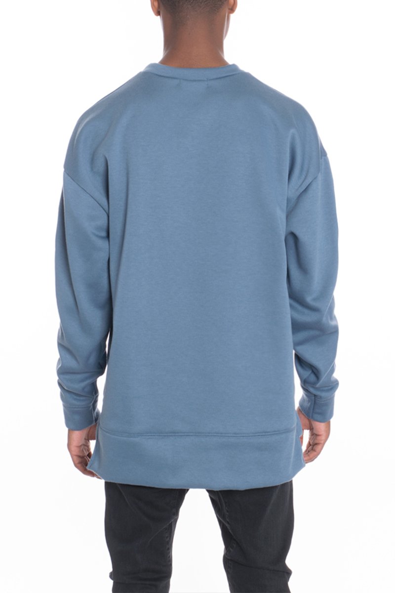 SIDEPANEL PULLOVER featuring a round neck, high-low design, and slit hem, made from a soft cotton-polyester blend.