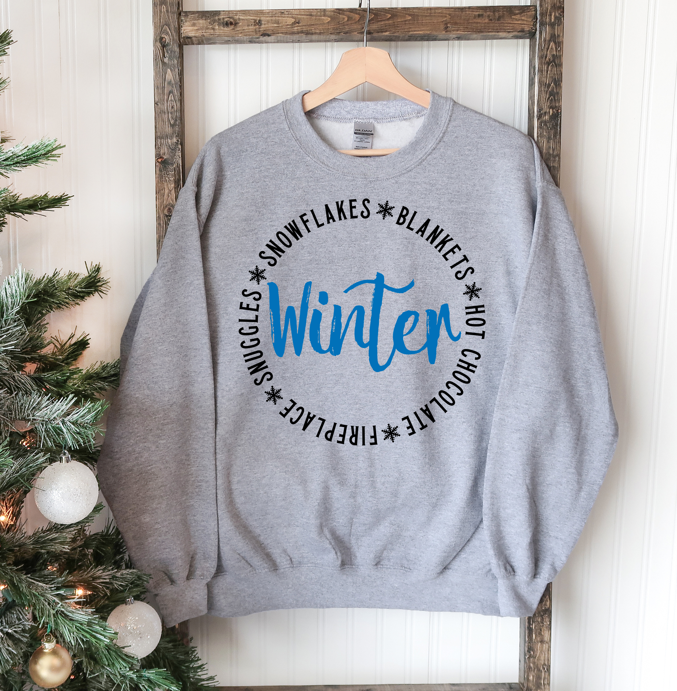 Cozy unisex Snowflakes Blankets Winter Sweatshirt in soft fabric, featuring a crew neck and rib-knit collar, perfect for winter wear.