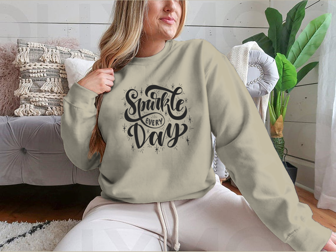 A hand-drawn illustration featuring the quote 'Sparkle Every Day' on a soft cotton-polyester blend fabric, showcasing a vibrant and uplifting design.