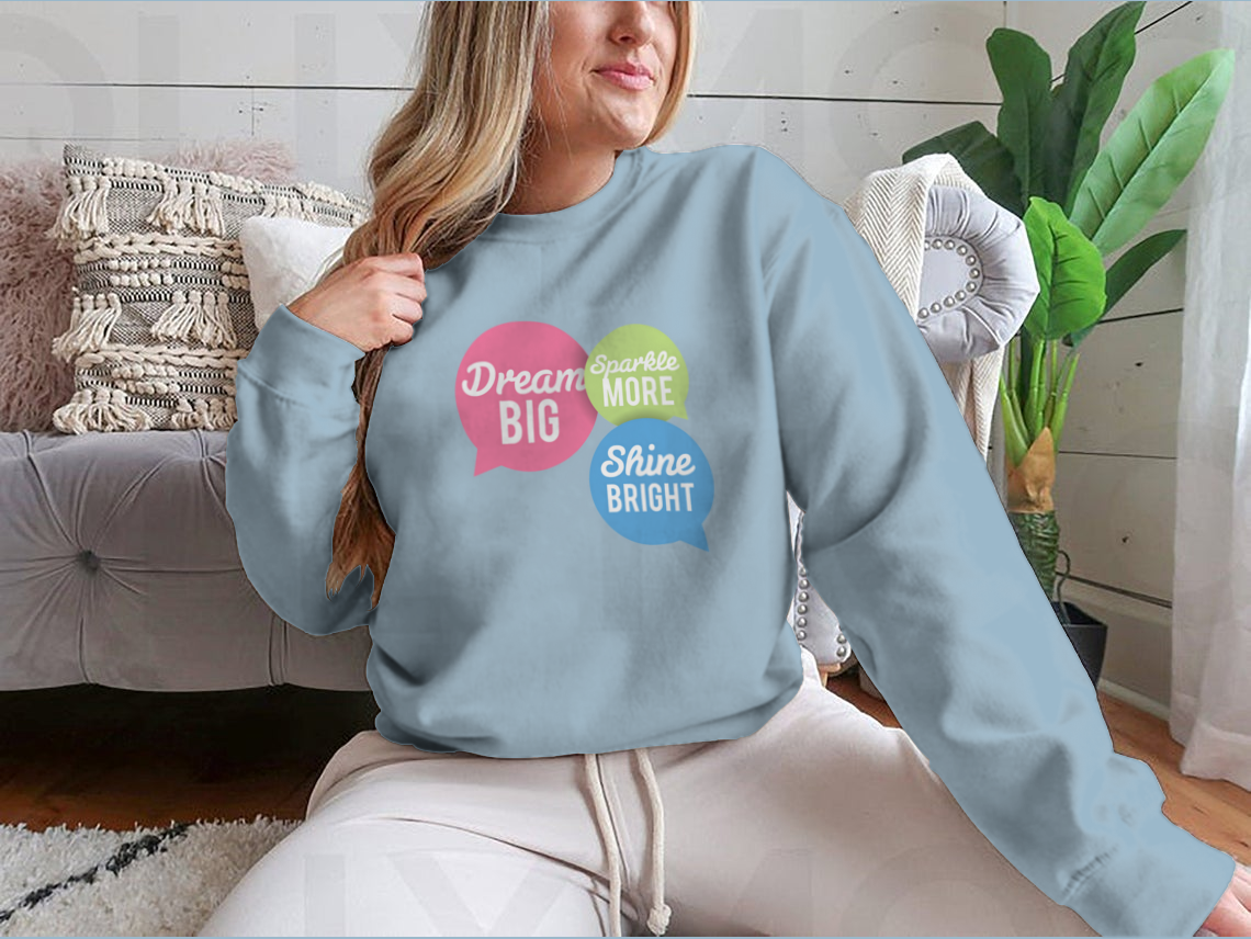 A stylish t-shirt featuring a motivational Dream Big quote in colorful speech bubbles, made from a soft cotton/polyester blend.