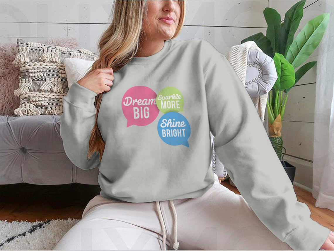 A stylish t-shirt featuring a motivational Dream Big quote in colorful speech bubbles, made from a soft cotton/polyester blend.