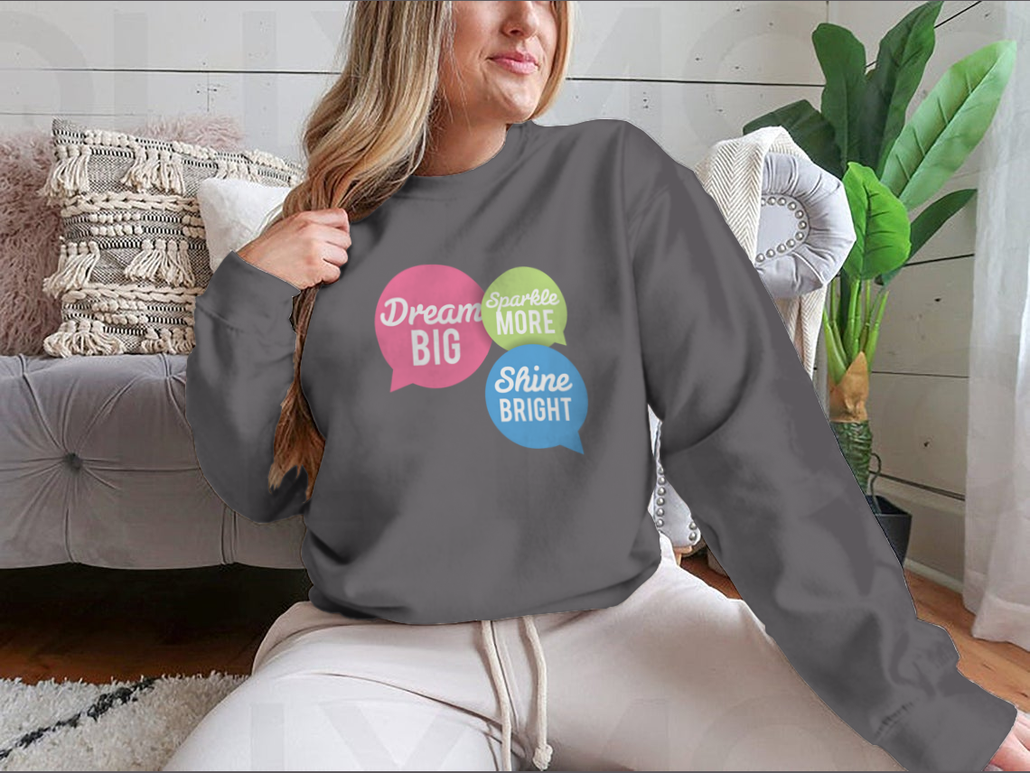 A stylish t-shirt featuring a motivational Dream Big quote in colorful speech bubbles, made from a soft cotton/polyester blend.