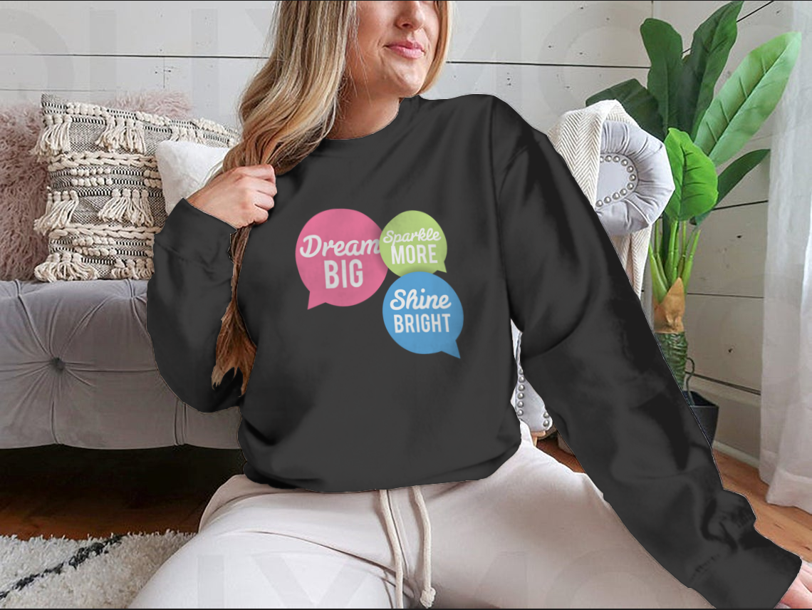 A stylish t-shirt featuring a motivational Dream Big quote in colorful speech bubbles, made from a soft cotton/polyester blend.