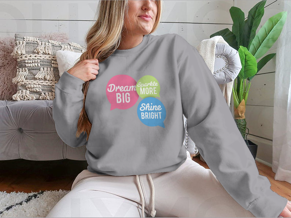 A stylish t-shirt featuring a motivational Dream Big quote in colorful speech bubbles, made from a soft cotton/polyester blend.