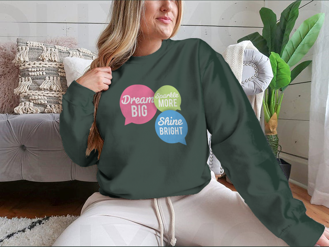 A stylish t-shirt featuring a motivational Dream Big quote in colorful speech bubbles, made from a soft cotton/polyester blend.