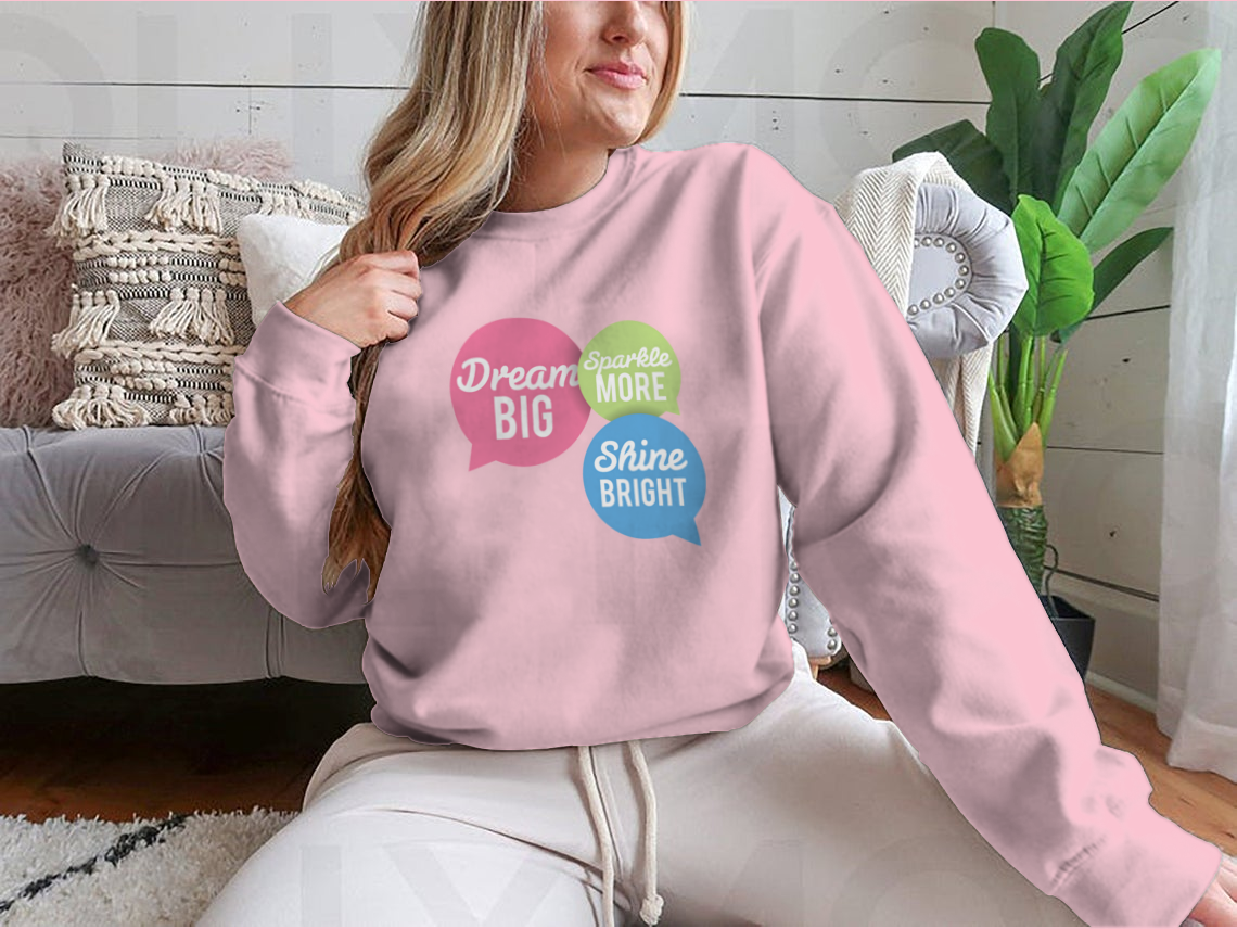 A stylish t-shirt featuring a motivational Dream Big quote in colorful speech bubbles, made from a soft cotton/polyester blend.