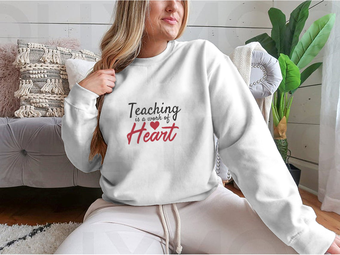 A stylish t-shirt featuring the quote 'Teaching Is A Work Of Heart', designed for educators, showcasing a comfortable fit and quality fabric.