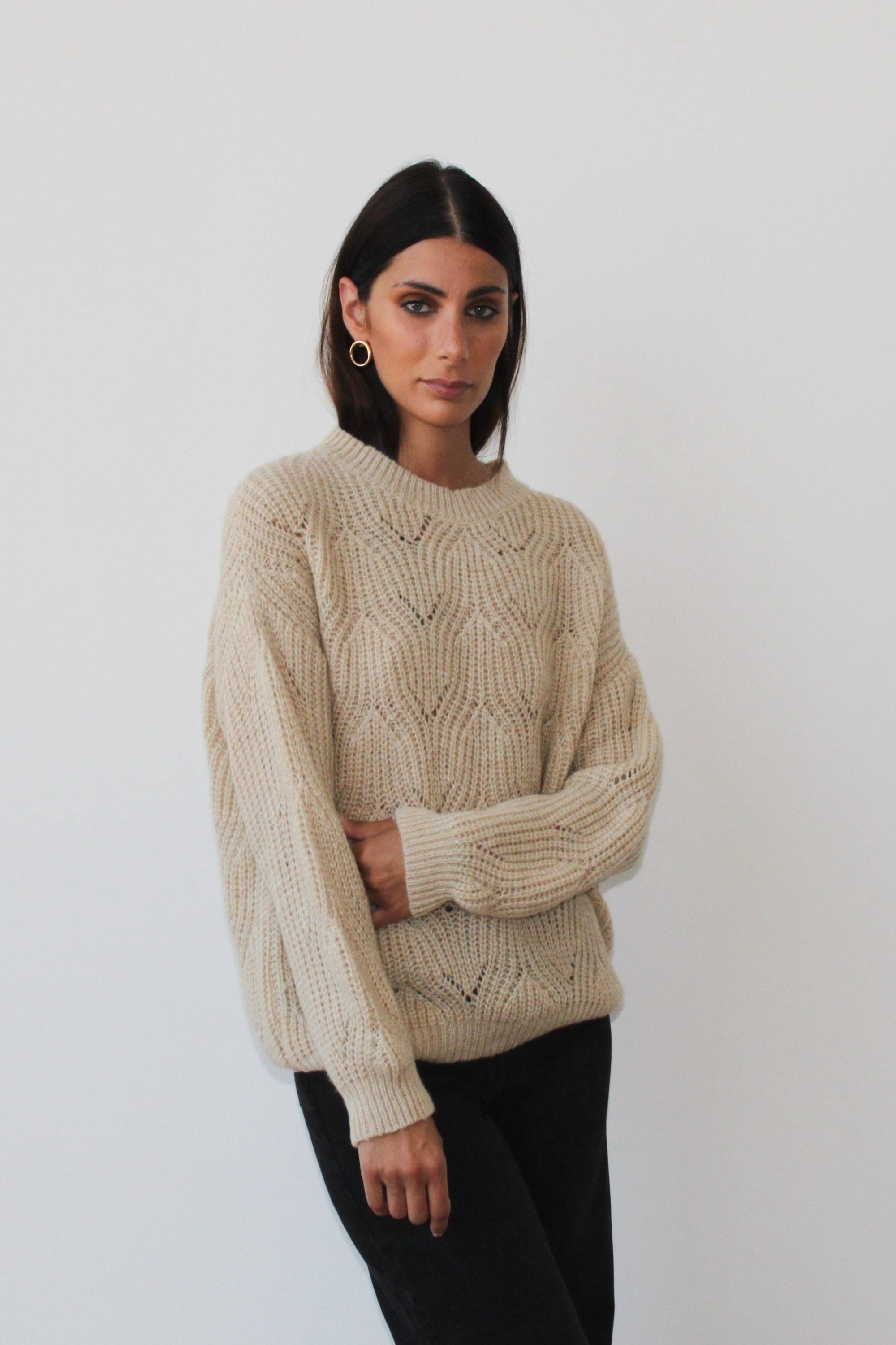 The Dune sweater displayed on a mannequin, showcasing its stylish design and versatile color.