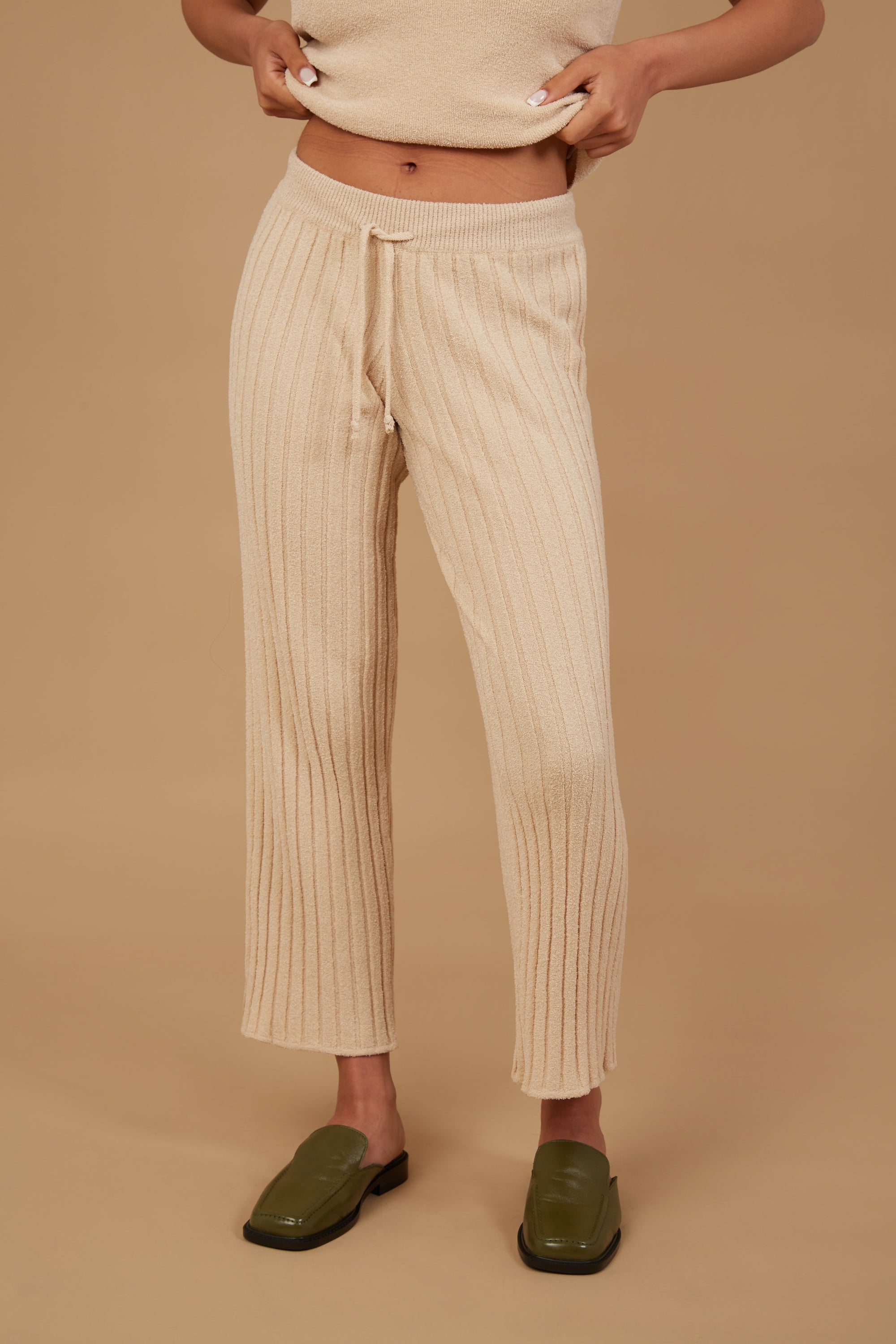 The Marie Pant in Champagne, featuring a soft corduroy texture, adjustable drawstring waist, and elastic ankle cuffs, perfect for smart casual wear.