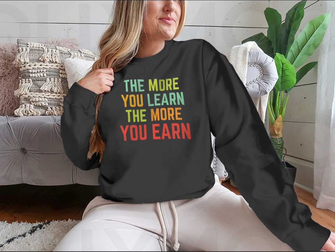 A stylish sweatshirt featuring the phrase 'The More You Learn', made from high-quality cotton, showcasing a classic fit and comfortable design.