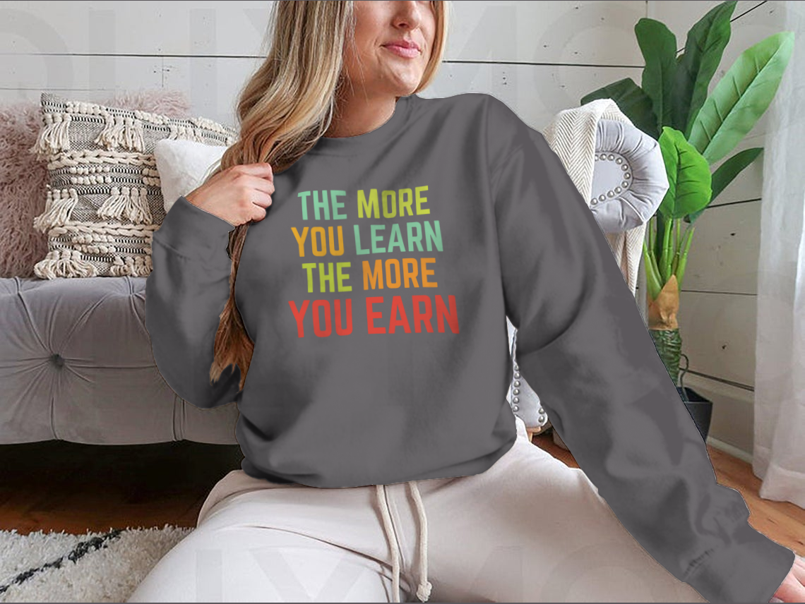 A stylish sweatshirt featuring the phrase 'The More You Learn', made from high-quality cotton, showcasing a classic fit and comfortable design.