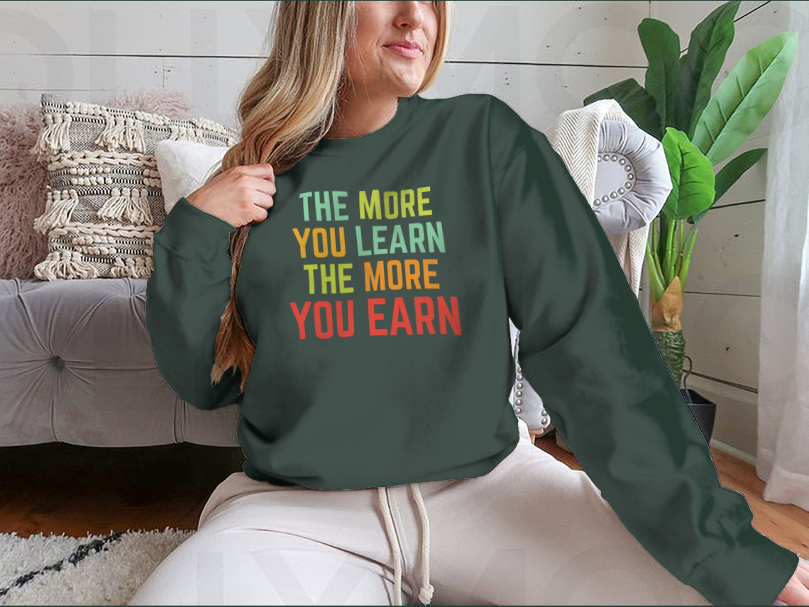 A stylish sweatshirt featuring the phrase 'The More You Learn', made from high-quality cotton, showcasing a classic fit and comfortable design.