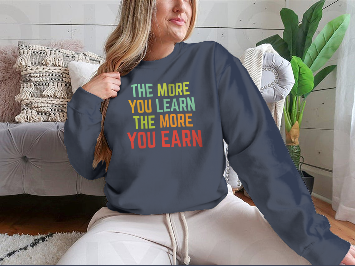 A stylish sweatshirt featuring the phrase 'The More You Learn', made from high-quality cotton, showcasing a classic fit and comfortable design.