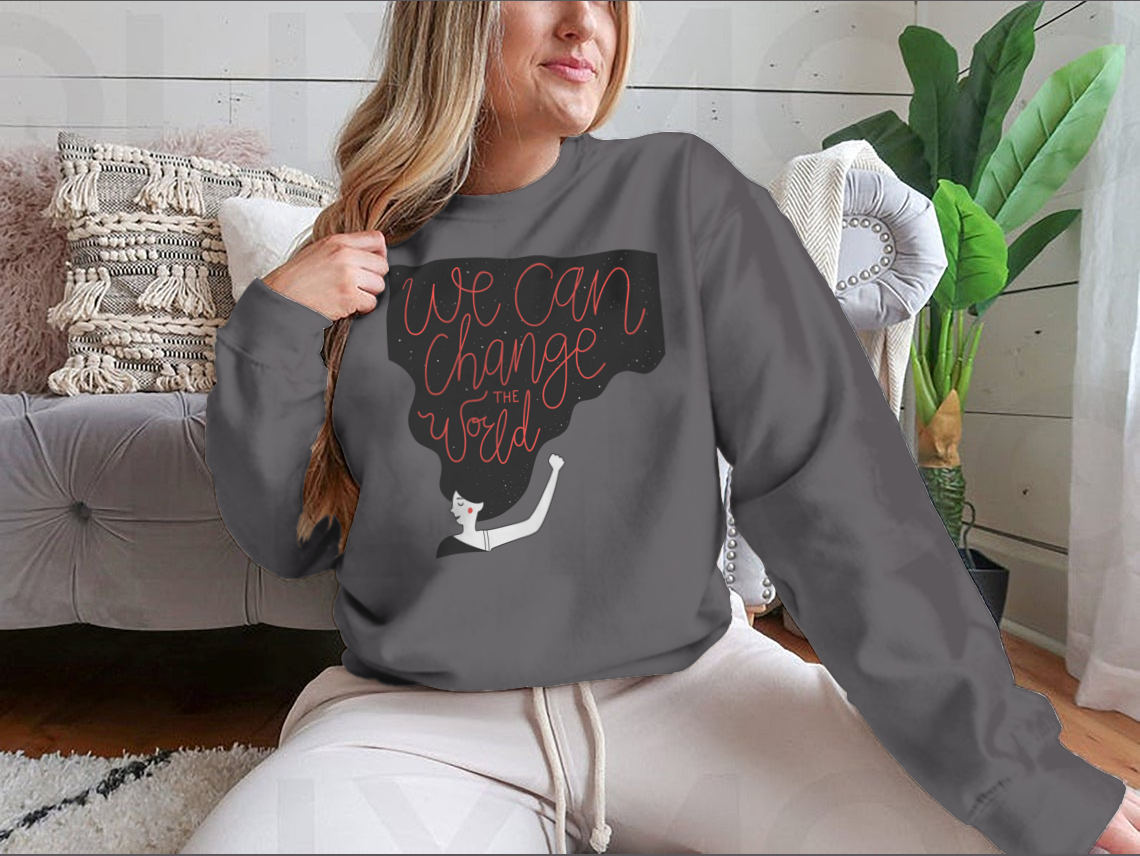 A cozy sweatshirt featuring the motivational quote 'We Can Change The World' in stylish typography, perfect for casual wear.