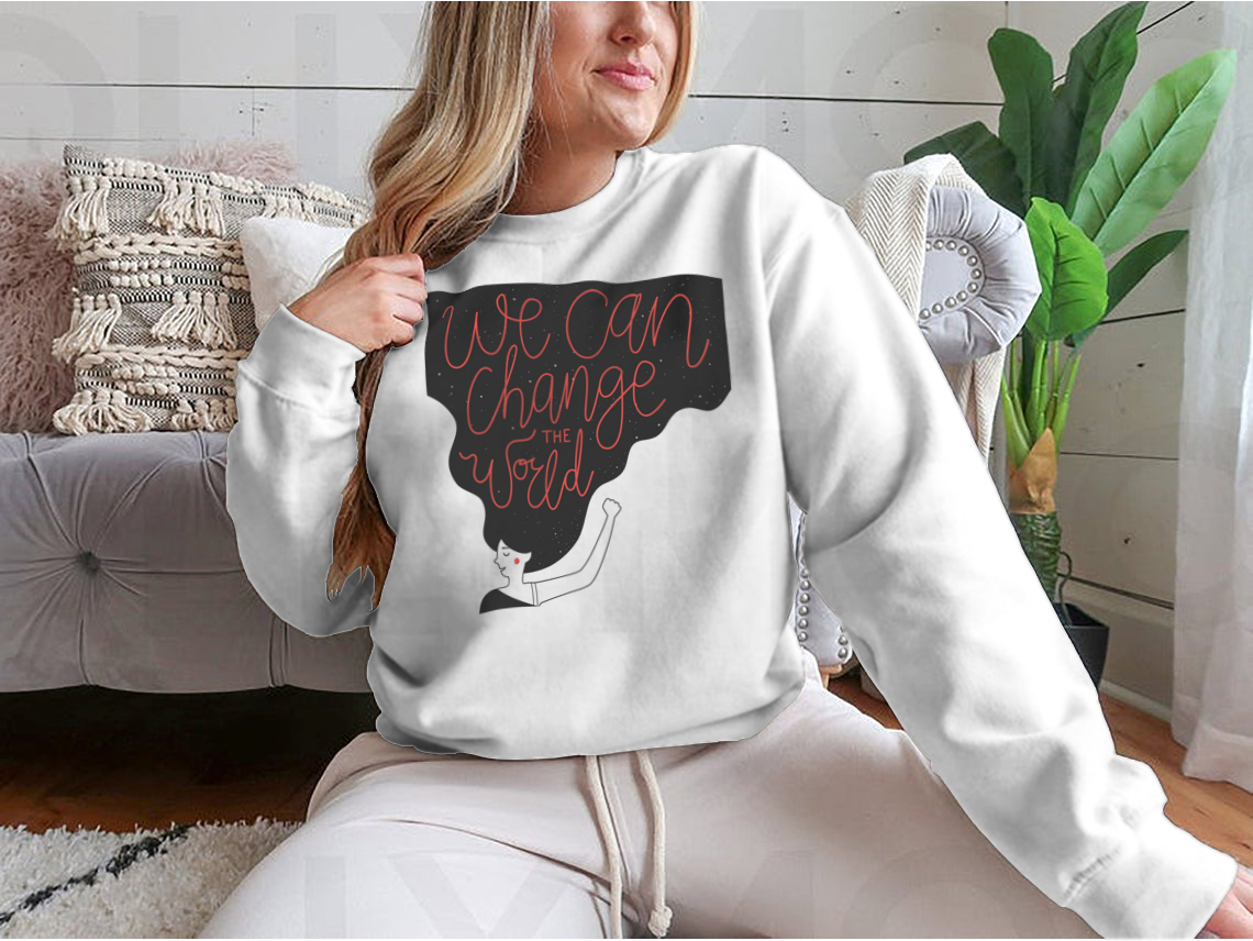 A cozy sweatshirt featuring the motivational quote 'We Can Change The World' in stylish typography, perfect for casual wear.