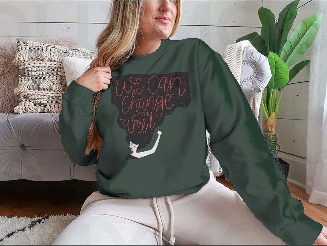 A cozy sweatshirt featuring the motivational quote 'We Can Change The World' in stylish typography, perfect for casual wear.