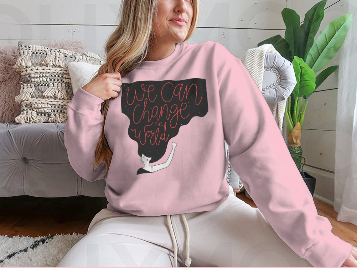 A cozy sweatshirt featuring the motivational quote 'We Can Change The World' in stylish typography, perfect for casual wear.