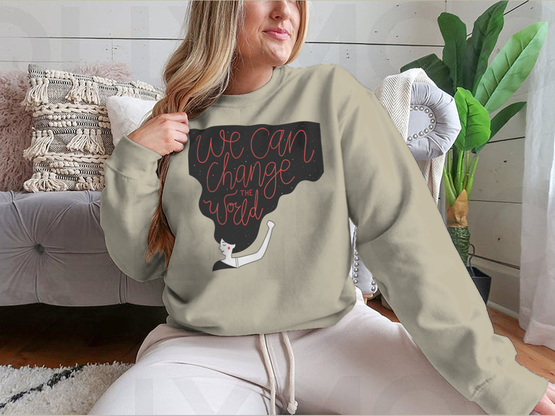 A cozy sweatshirt featuring the motivational quote 'We Can Change The World' in stylish typography, perfect for casual wear.