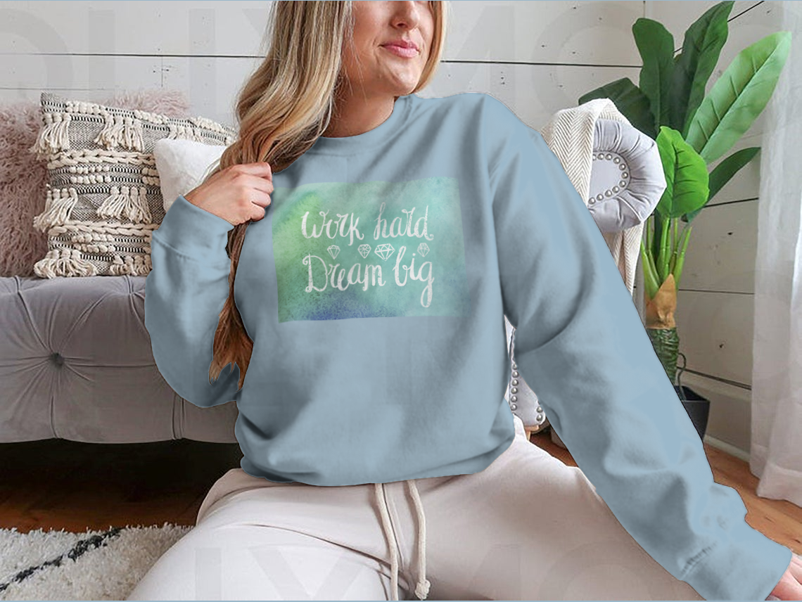 A cozy sweatshirt featuring the inspirational quote 'Work Hard Dream Big', made from a soft cotton/polyester blend, perfect for casual wear.