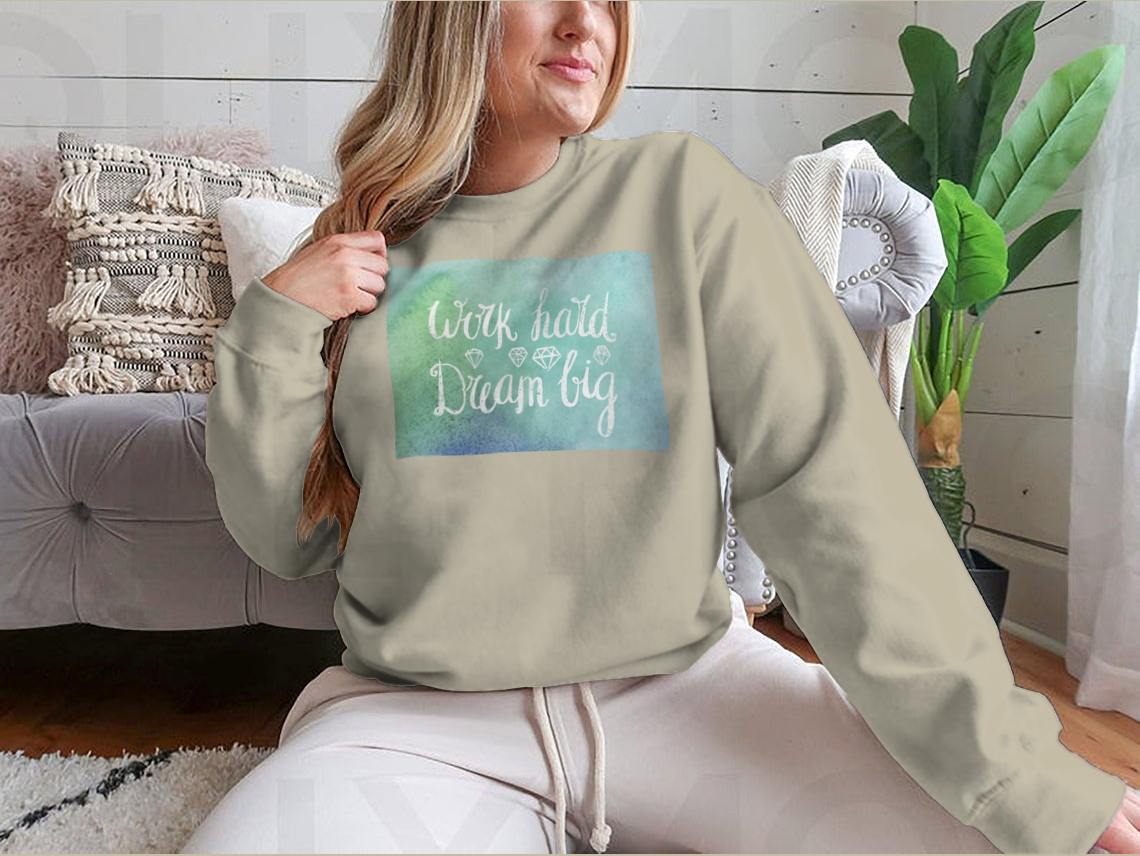 A cozy sweatshirt featuring the inspirational quote 'Work Hard Dream Big', made from a soft cotton/polyester blend, perfect for casual wear.