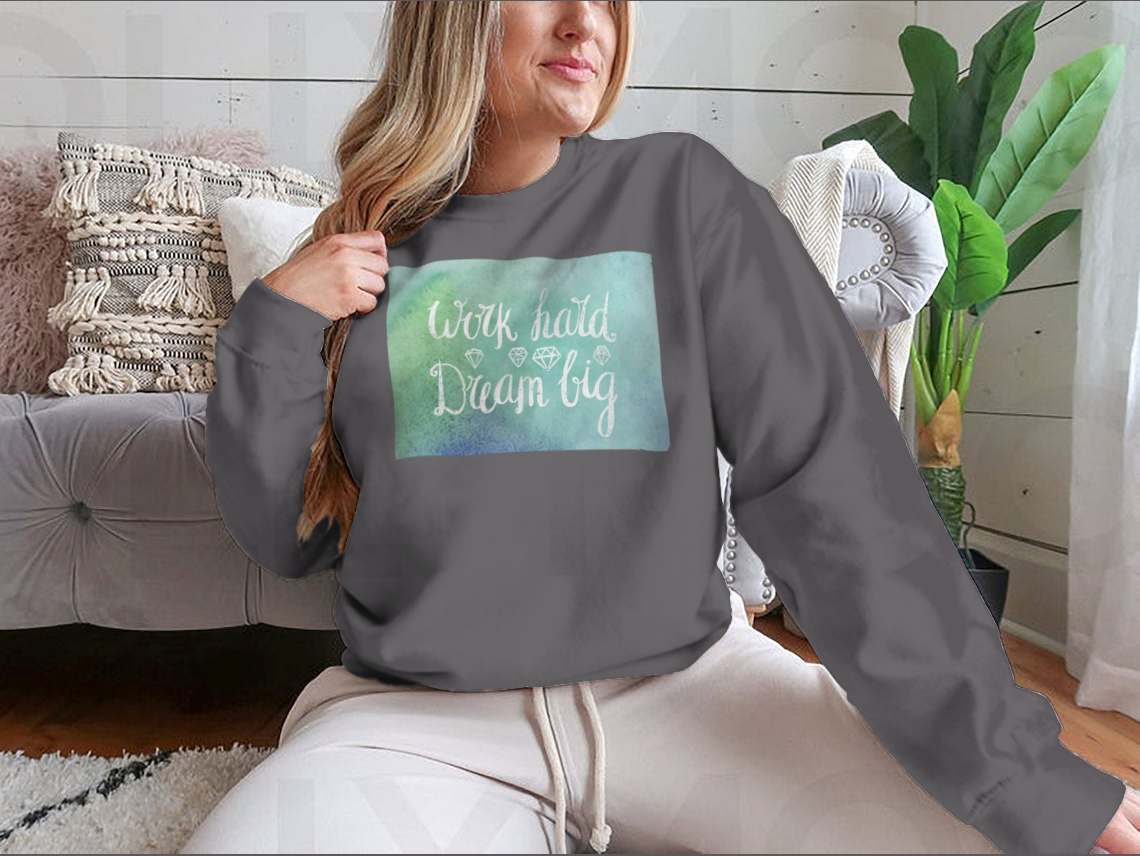 A cozy sweatshirt featuring the inspirational quote 'Work Hard Dream Big', made from a soft cotton/polyester blend, perfect for casual wear.