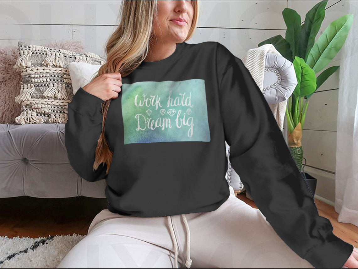 A cozy sweatshirt featuring the inspirational quote 'Work Hard Dream Big', made from a soft cotton/polyester blend, perfect for casual wear.