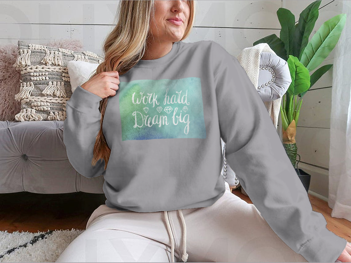 A cozy sweatshirt featuring the inspirational quote 'Work Hard Dream Big', made from a soft cotton/polyester blend, perfect for casual wear.