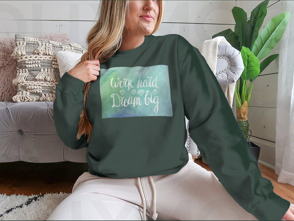 A cozy sweatshirt featuring the inspirational quote 'Work Hard Dream Big', made from a soft cotton/polyester blend, perfect for casual wear.