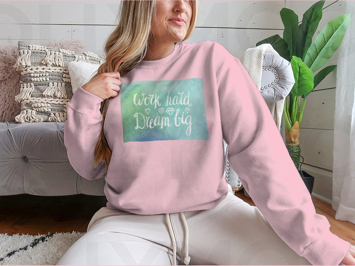 A cozy sweatshirt featuring the inspirational quote 'Work Hard Dream Big', made from a soft cotton/polyester blend, perfect for casual wear.