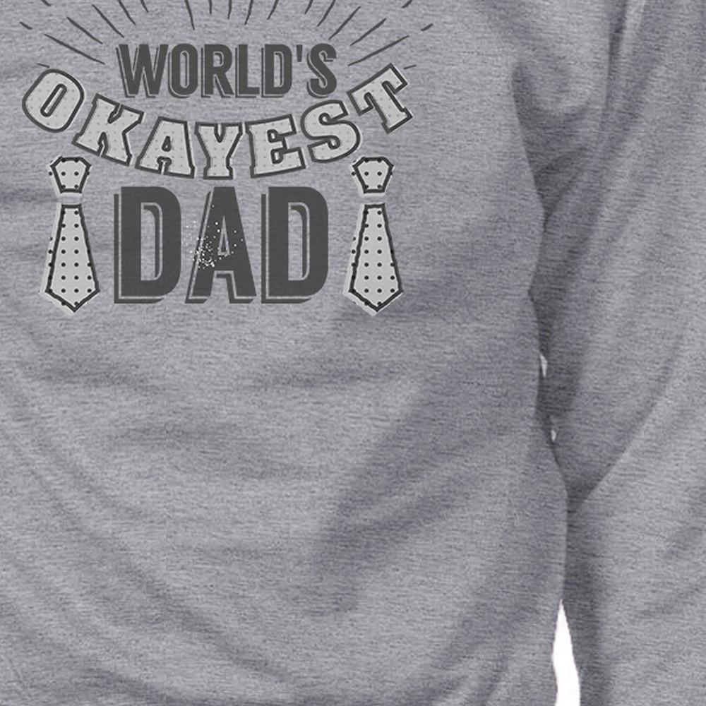 A grey vintage style sweatshirt with the text 'World's Okayest Dad' printed on it, showcasing a comfortable and humorous design for fathers.