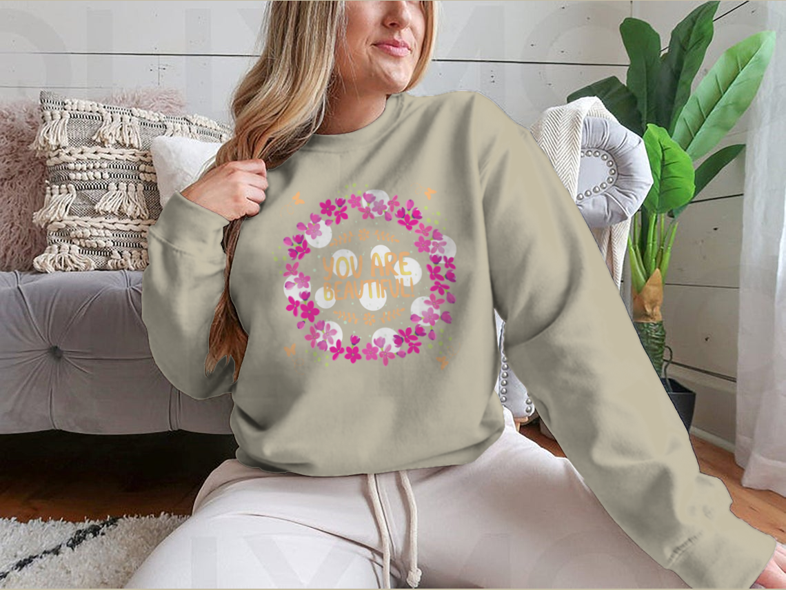 A cozy sweatshirt featuring the inspirational phrase 'You Are Beautiful' in a stylish design, perfect for casual wear.