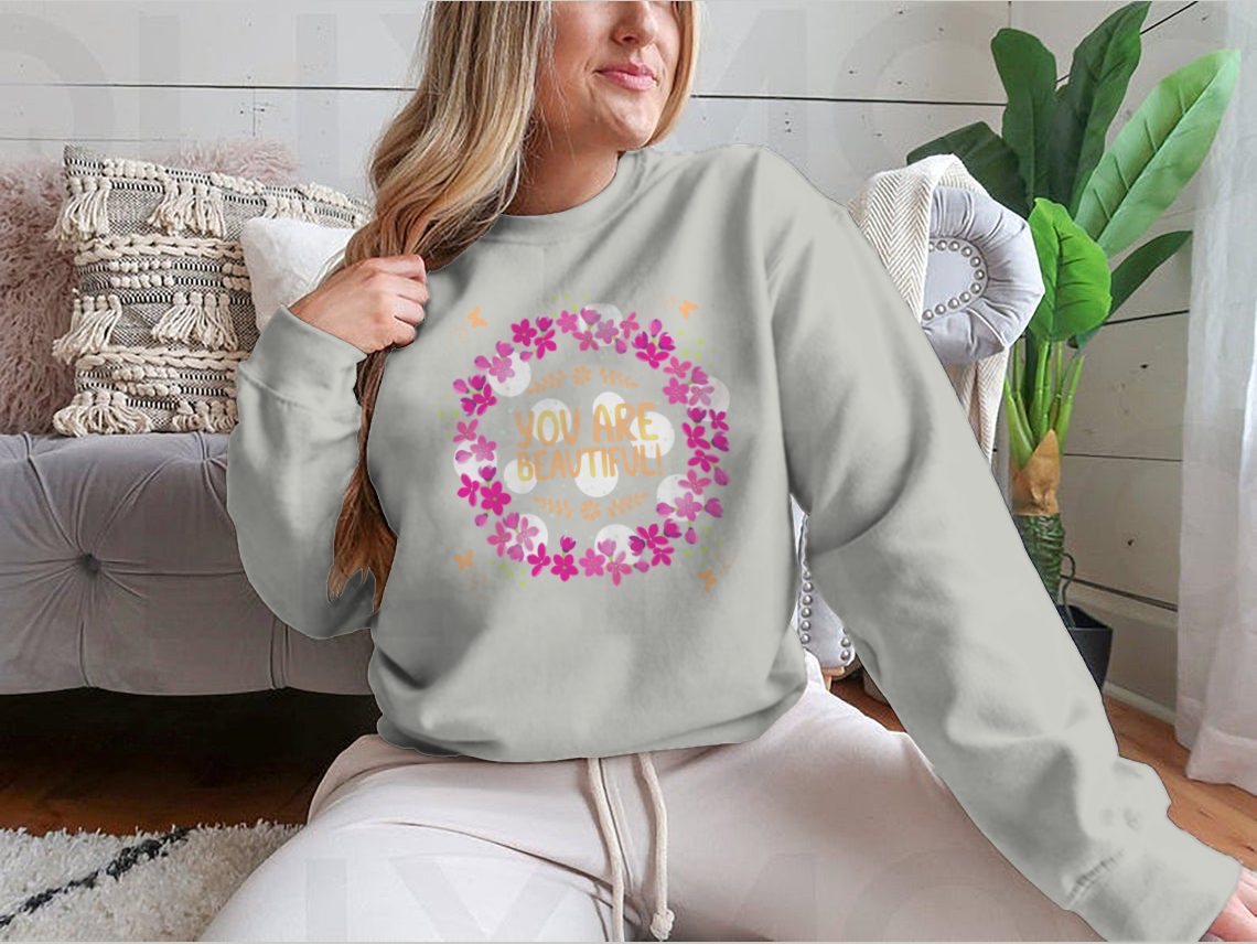 A cozy sweatshirt featuring the inspirational phrase 'You Are Beautiful' in a stylish design, perfect for casual wear.