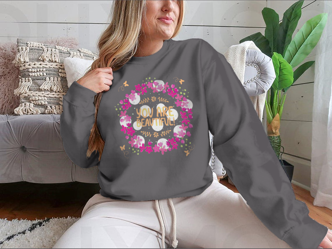 A cozy sweatshirt featuring the inspirational phrase 'You Are Beautiful' in a stylish design, perfect for casual wear.