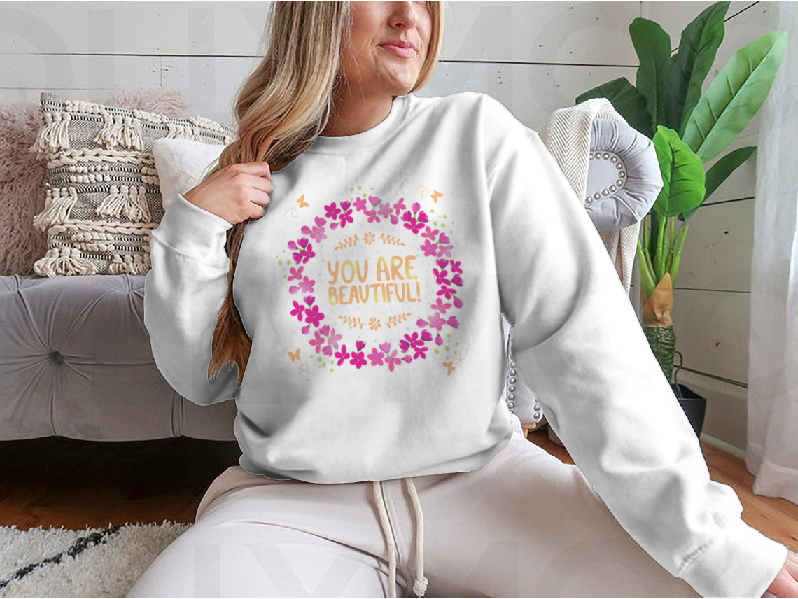 A cozy sweatshirt featuring the inspirational phrase 'You Are Beautiful' in a stylish design, perfect for casual wear.