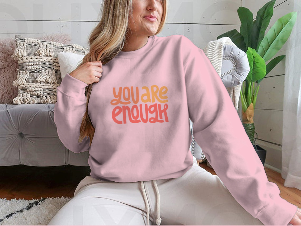 A cozy sweatshirt featuring the inspirational phrase 'You Are Enough' in stylish typography, perfect for casual wear.