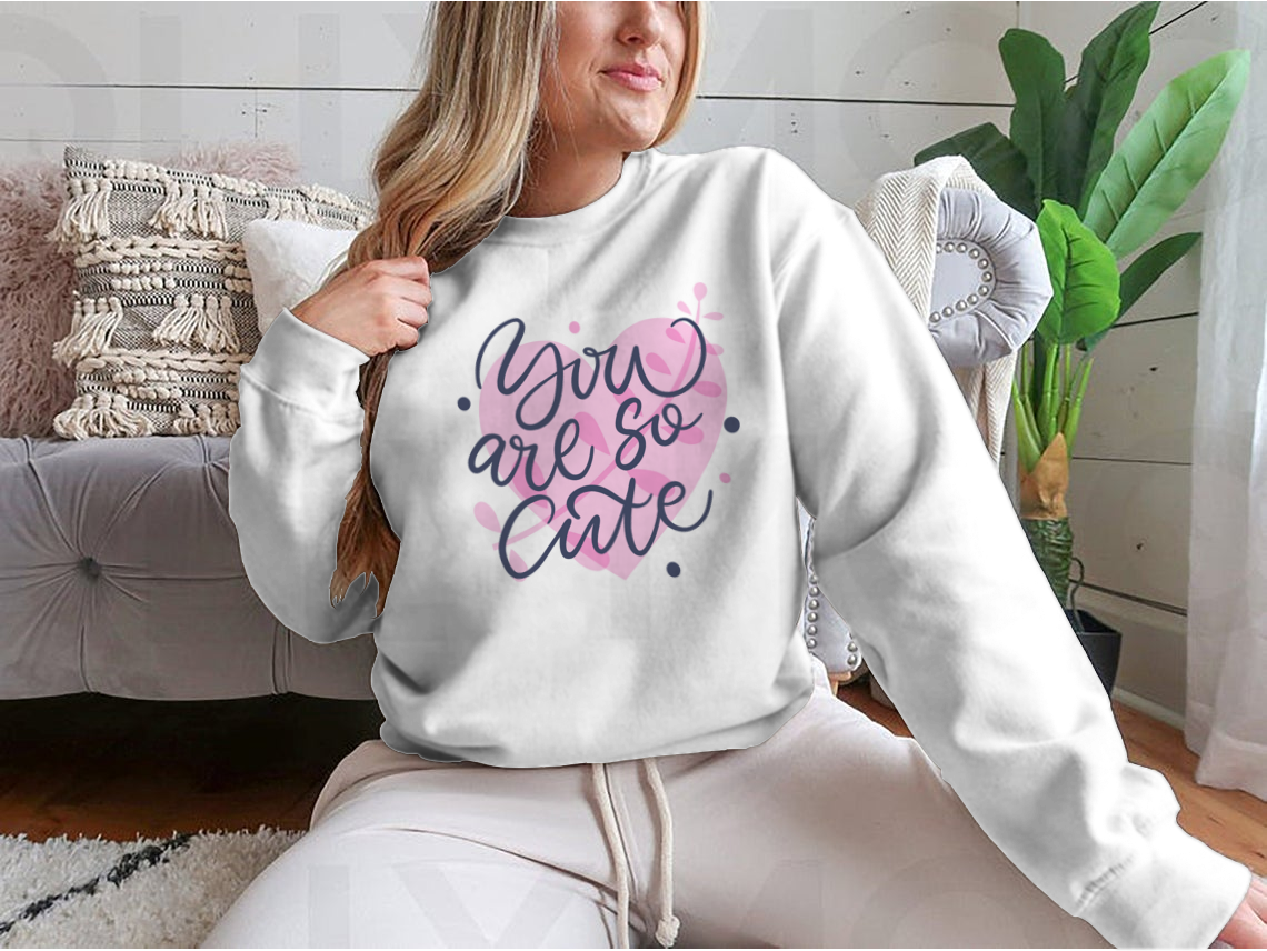 A vibrant t-shirt featuring the phrase 'You Are So Cute' in bright colored modern hand-drawn lettering, showcasing a playful and stylish design.