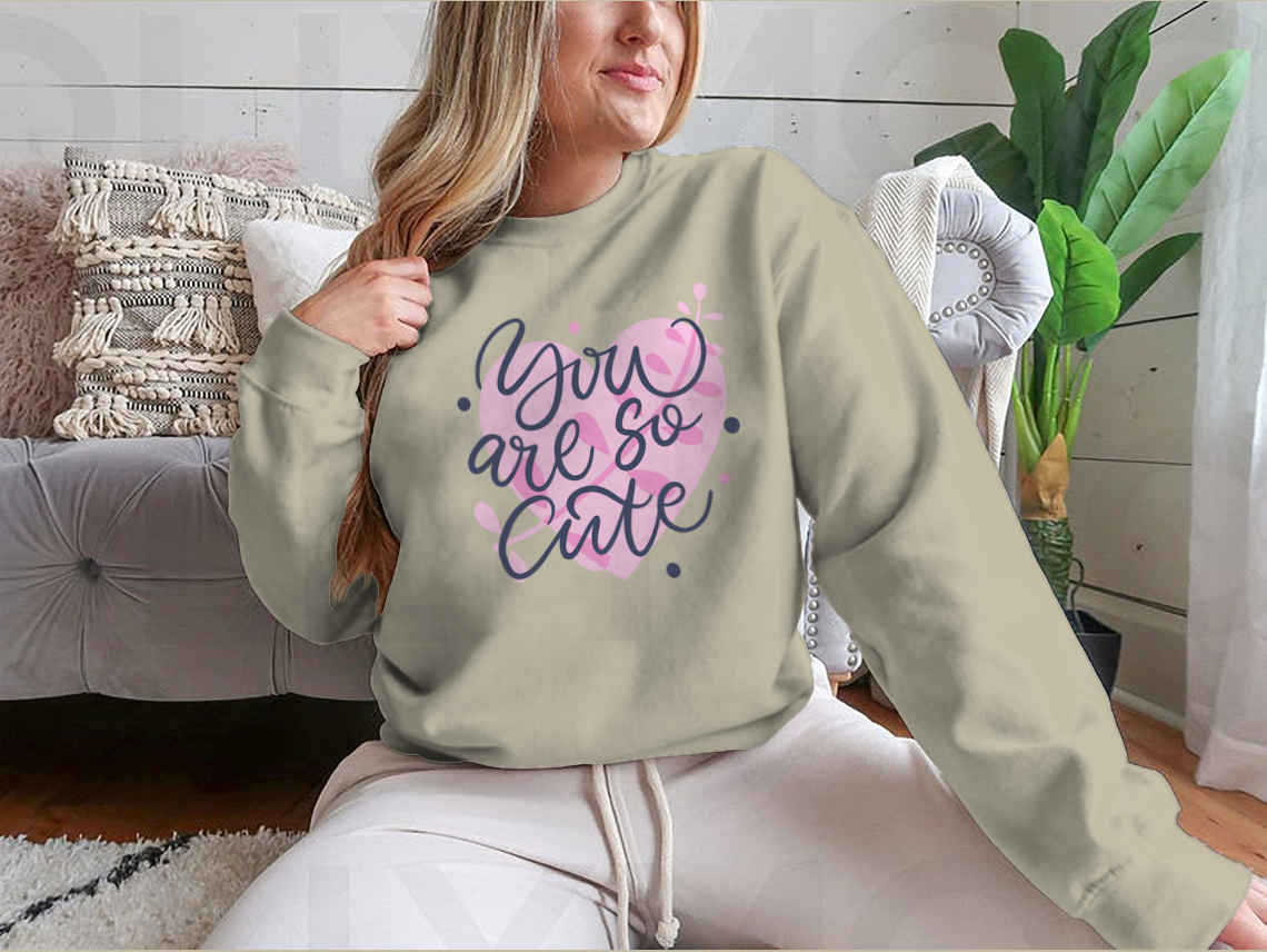 A vibrant t-shirt featuring the phrase 'You Are So Cute' in bright colored modern hand-drawn lettering, showcasing a playful and stylish design.