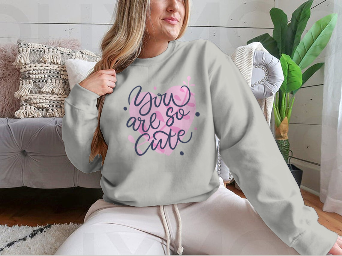 A vibrant t-shirt featuring the phrase 'You Are So Cute' in bright colored modern hand-drawn lettering, showcasing a playful and stylish design.