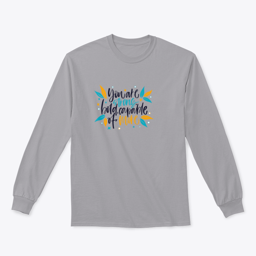 A motivational apparel piece featuring the phrase 'You Are Strong, Bold, Capable Of More' in a stylish design, made from a comfortable cotton-polyester blend.